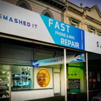 Ponsonby Smashed It Store exterior with bright signage fast phone and Mac repair next to Saben boutique.